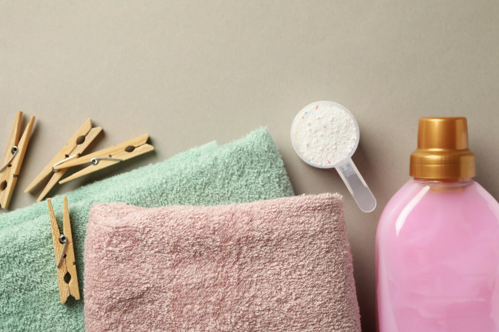 Laundry accessories on gray background, top view